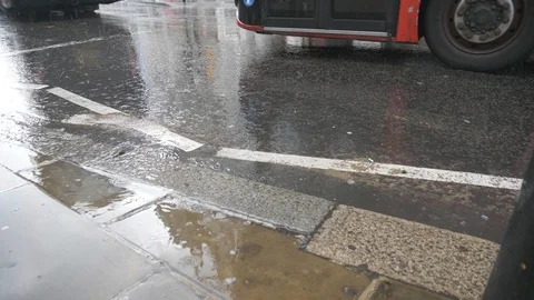 Raindrops falling down on a European road. Stock Footage 107948871