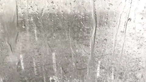Raindrops falling down on an urban pavement Stock Footage 97823878