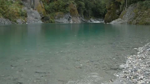 Raindrops falling gently on clear blue river Video stock 140610670