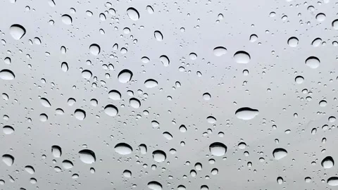 Raindrops falling on a glass window Stock Footage 336112959