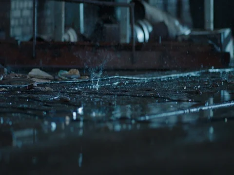Raindrops falling into the ground. Old fabric building. Macro shot, close up Stock Footage 70214435
