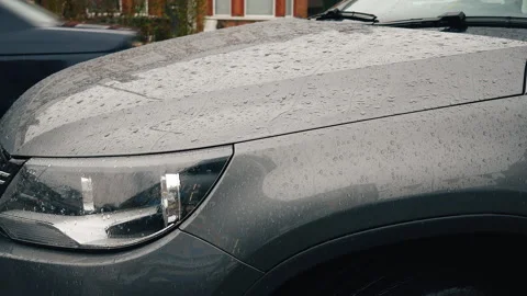 Raindrops falling on a hood of a car. Rainy day. Stock Footage 88638465