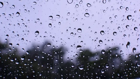 Raindrops falling onto the mirror during the daytime. Stock Footage 321936130