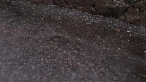 Raindrops Falling into Muddy Puddle Close-up Stock Footage 329207329