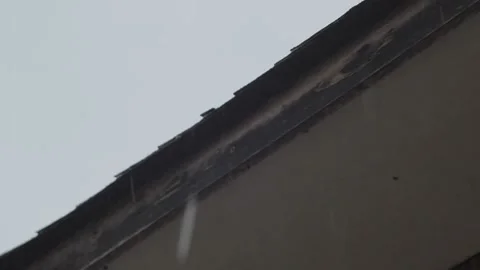 Raindrops falling next to the roof Stock Footage 233382089