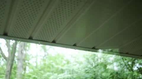 Raindrops Falling over Soffit From Full Gutter in Residential Home Stock Footage 335663233