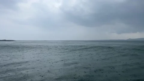 Raindrops falling on the overflowing sea Stock Footage 206758222