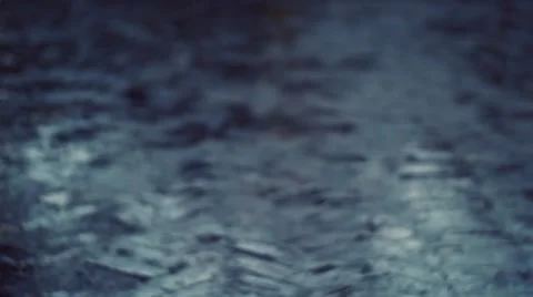 Raindrops falling on Paved Street Stock Footage 58382396