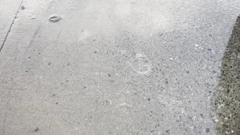 Raindrops falling on the pavement Stock Footage 279711561