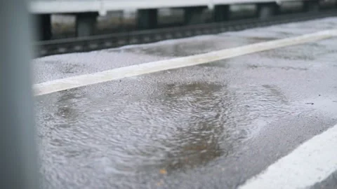 Raindrops falling on the platform asphalt Stock-Footage 138133840
