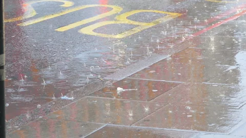 Raindrops falling on  a puddle on a road. Stock Footage 94394973