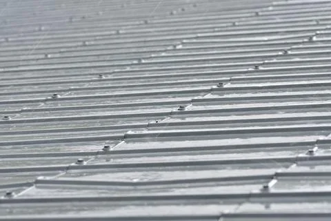 Raindrops falling on the roof during a downpour. Rain. Day. Stock Photos