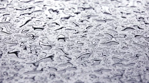 Raindrops falling in slow motion on metal surface Stock Footage 67830349