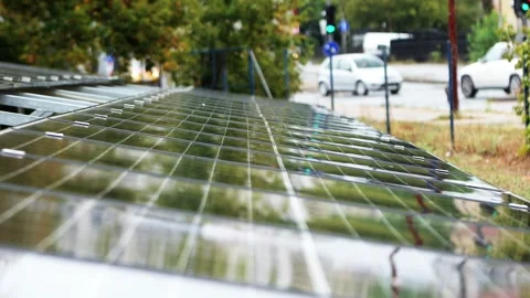 Raindrops falling on solar panels during rainy day Stock Footage 345437516