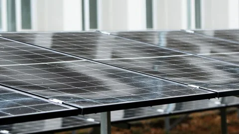 Raindrops falling on solar panels producing green energy Stock Footage 345437464