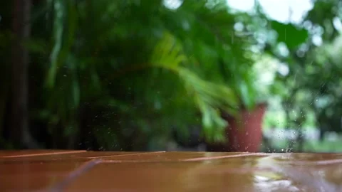 Raindrops falling on the tiled floor of the outside balcony. Rainy season in Stock Footage 199544411