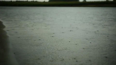 Raindrops falling on water Stock Footage