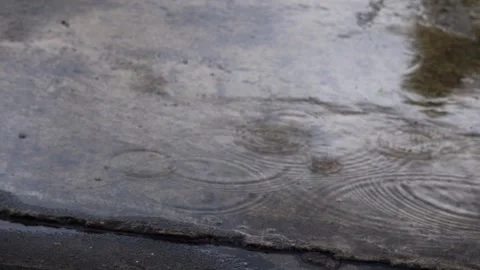 Raindrops Falling on Wet Concrete Surface Stock Footage 339561924