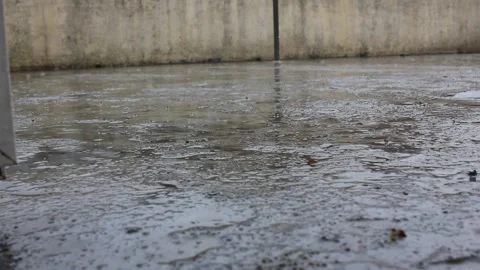 Raindrops falling on a wet terrace floor during a spring rain shower 스톡 동영상 334581360