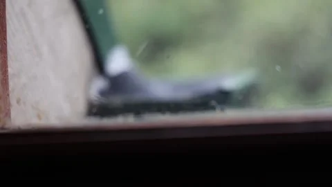 Raindrops falling on a window during a storm 動画素材 336304117