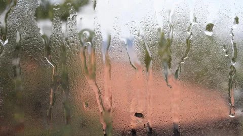 Raindrops falling on the window glass Stock Footage 278686485