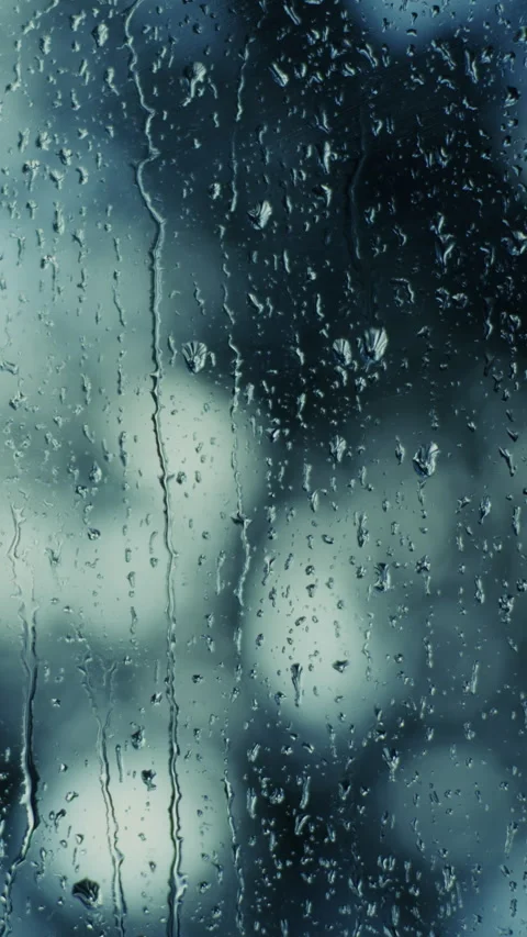 Raindrops falling on window glass producing wet abstract texture Stock Footage 321398350