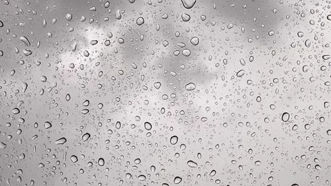 Raindrops falling on window glass surface Stock Footage 296567360