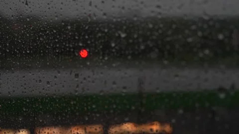 Raindrops falling on window in low light Stock Footage 141229174