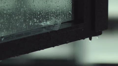 Raindrops Falling on Window Panel Slow Motion Stock Footage 149871622