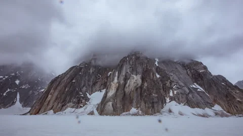 Raindrops falling on a window with snowy mountains view Stock Footage 335104809