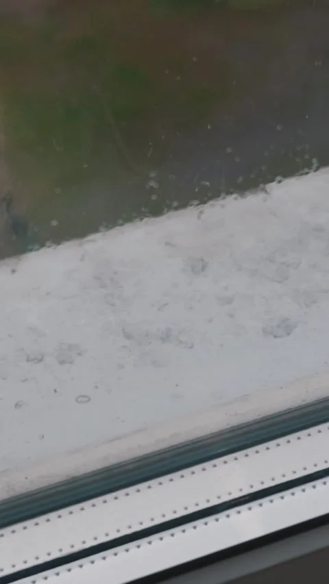 Raindrops Falling on Windowpane and White Windowsill on Rainy Day Stock Footage 335233072