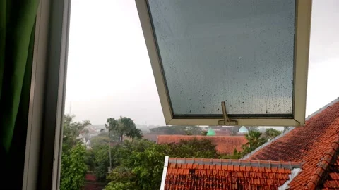 Raindrops falling on the windows of the building on the top floor Stock Footage 182201085