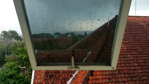 Raindrops falling on the windows of the building on the top floor Stock Footage 182201125