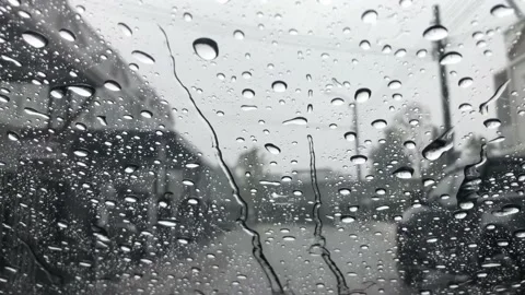 Raindrops falling on the windshield of the car Stock Footage 234764757