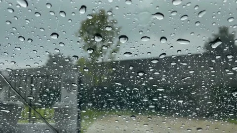 Raindrops falling on the windshield of the car Stock Footage 234765064
