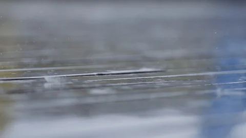 Raindrops falling on wooden deck Drops of water on boards Slow motion Macro Stock-Footage 96117921