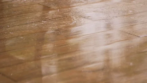 Raindrops falling on the wooden floor Stock Footage 128030642