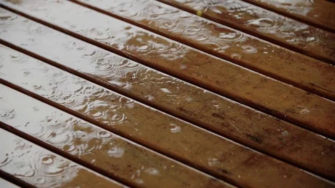 Raindrops falling on the wooden floor Stock Footage 128093794