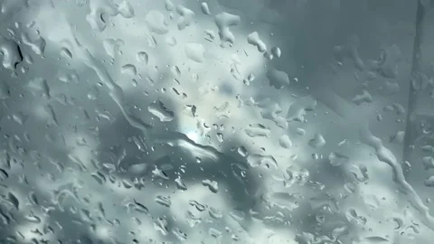 Raindrops flow down the glass of the car. cloudy weather Video stock 229893745