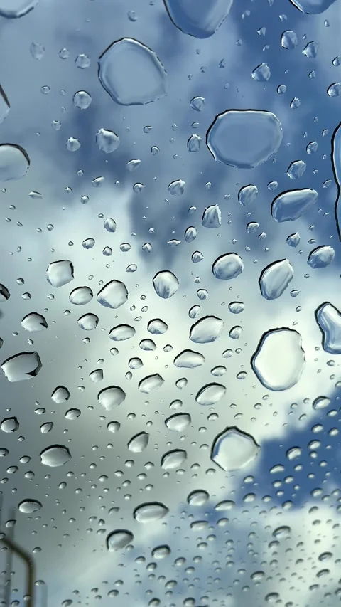 Raindrops flow down the glass ceiling of a car window Stock Footage 304879329
