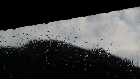 Raindrops flow down the glass in the window Stock Footage 79434696