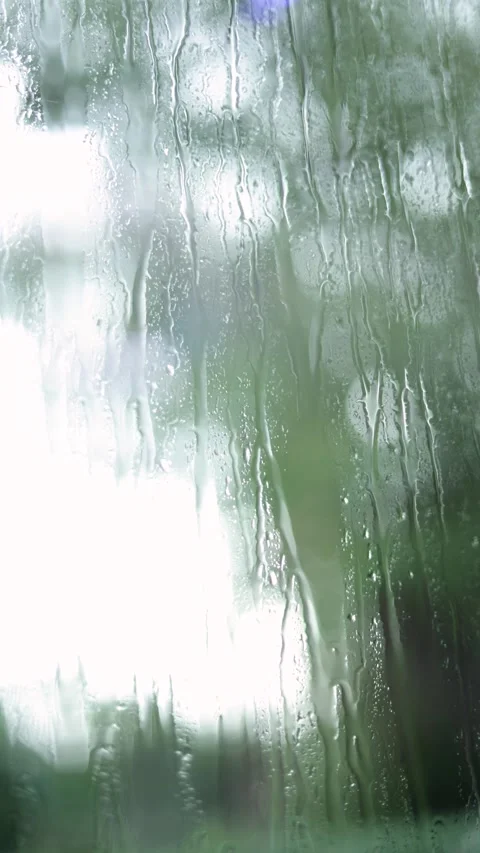 Raindrops Flow Down The Window, Blurred Background, Vertical Close-Up Shot Stock Footage 292326137