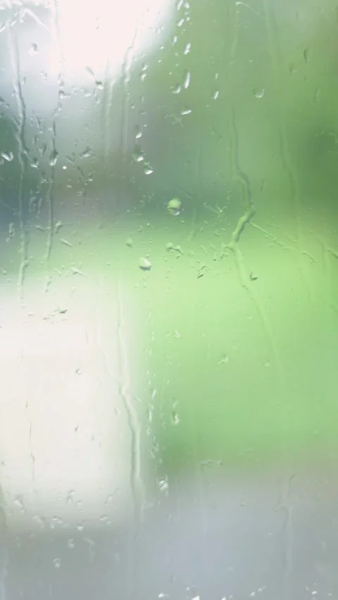 Raindrops Flow Down The Window, Blurred Background, Vertical Close-Up Shot Stock Footage 292326837