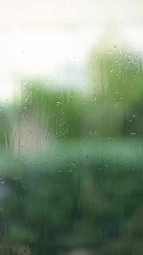 Raindrops Flow Down The Window, Blurred Background, Vertical Close-Up Shot Stock Footage 292326870