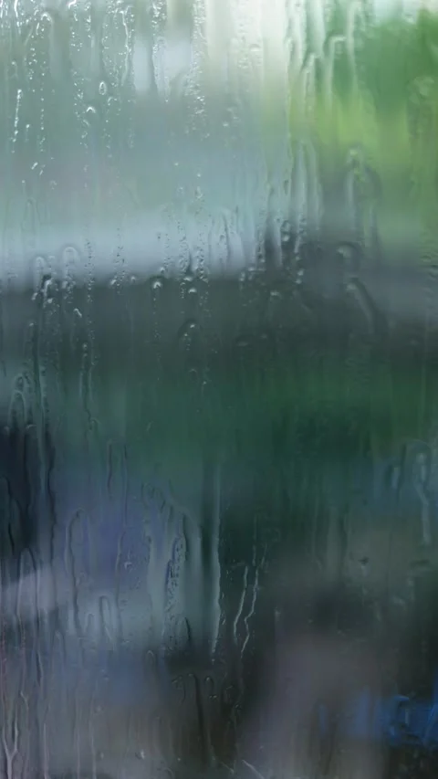Raindrops Flow Down The Window, Blurred Background, Vertical Close-Up Shot Stock Footage 292329483