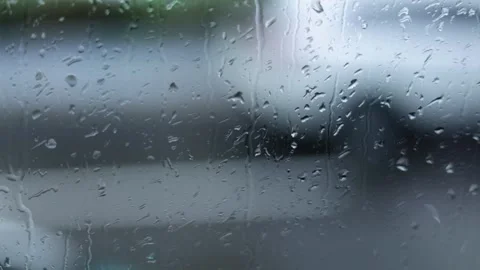 Raindrops Flow Down The Window, City Traffic Blurred Background, Close-Up Shot Stock Footage 292302966