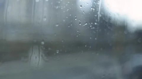 Raindrops Flow Down The Window, City Landscape Blurred Background, Close-Up Shot Stock Footage 292313412