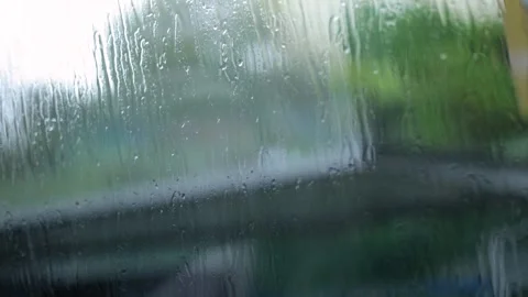 Raindrops Flow Down The Window, City Blurred Background, Close-Up Shot Stock Footage 292315447