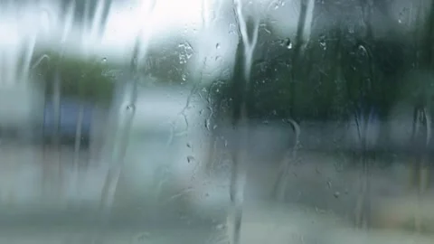 Raindrops Flow Down The Window, City Landscape Blurred Background, Close-Up Shot Stock Footage 292323099