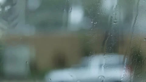 Raindrops Flow Down The Window, City Blurred Background, Close-Up Shot Stock Footage 292323357